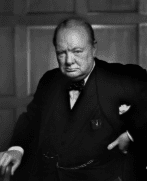 Seated older man in suit with stern expression