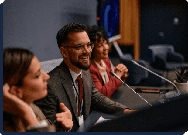 Smiling panelists speaking at conference