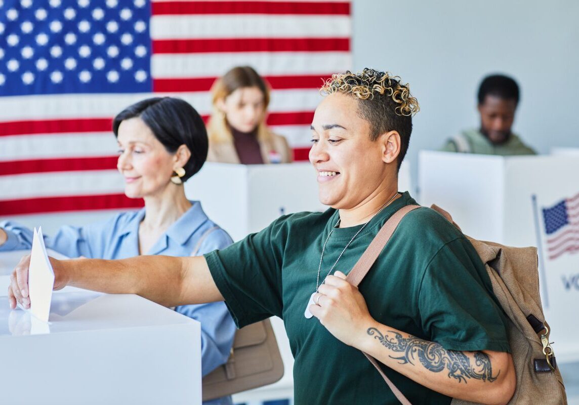 People voting at polling stations, American flag.
